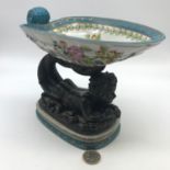 An antique style porcelain and bronzed metal figure dish. Ornately decorated with flowers, gold