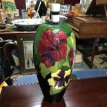 A Large Moorcroft Hibiscus pattern table lamp. In a working condition. Measures 42cm in height