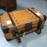 A leather bound travel case with original leather strapping