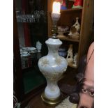 An Antique opalescent glass table lamp designed with raised relief floral moulds. In a working