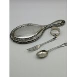 A Birmingham silver hand mirror, Birmingham silver napkin ring, Sheffield silver tea spoon &