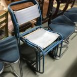 A Lot of four vintage metal stacking chairs.