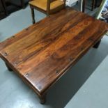 A Contemporary hardwood lounge table. Measures 40x120x71cm