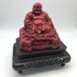 Antique Chinese red Lacquered Hotei Buddha statue on hand carved wooden stand. Measures 22cm in