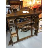 A Victorian oak over mantle oak wall mirror, with fitted shelving and glass panels