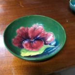 A Moorcroft Hibiscus pattern bowl. Measures 5x14.5cm