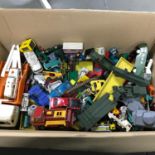 A Box of vintage playworn models which includes corgi.
