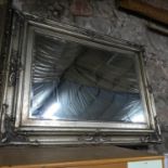 A Large Gallery silver ornate framed mirror. Mirror has bevel edging. Measures 124x94cm