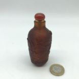 A Vintage Chinese amber glass perfume/ snuff bottle. Measures 8.5cm in height