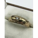 A Gents 9ct gold ring set with a single diamond stone, Ring size R 1/2. Weighs 4.18grams