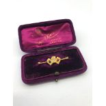 A High grade (22-24ct) gold bar brooch set with three playing cards which hold semi precious stones,