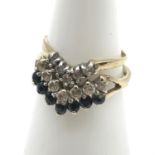 Two 9ct gold ladies wish bone rings set with clear stones and black stones. Ring size L (BLACK AND