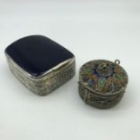 A Lot of two white metal trinket boxes. One is made with white metal and enamel which the trinket