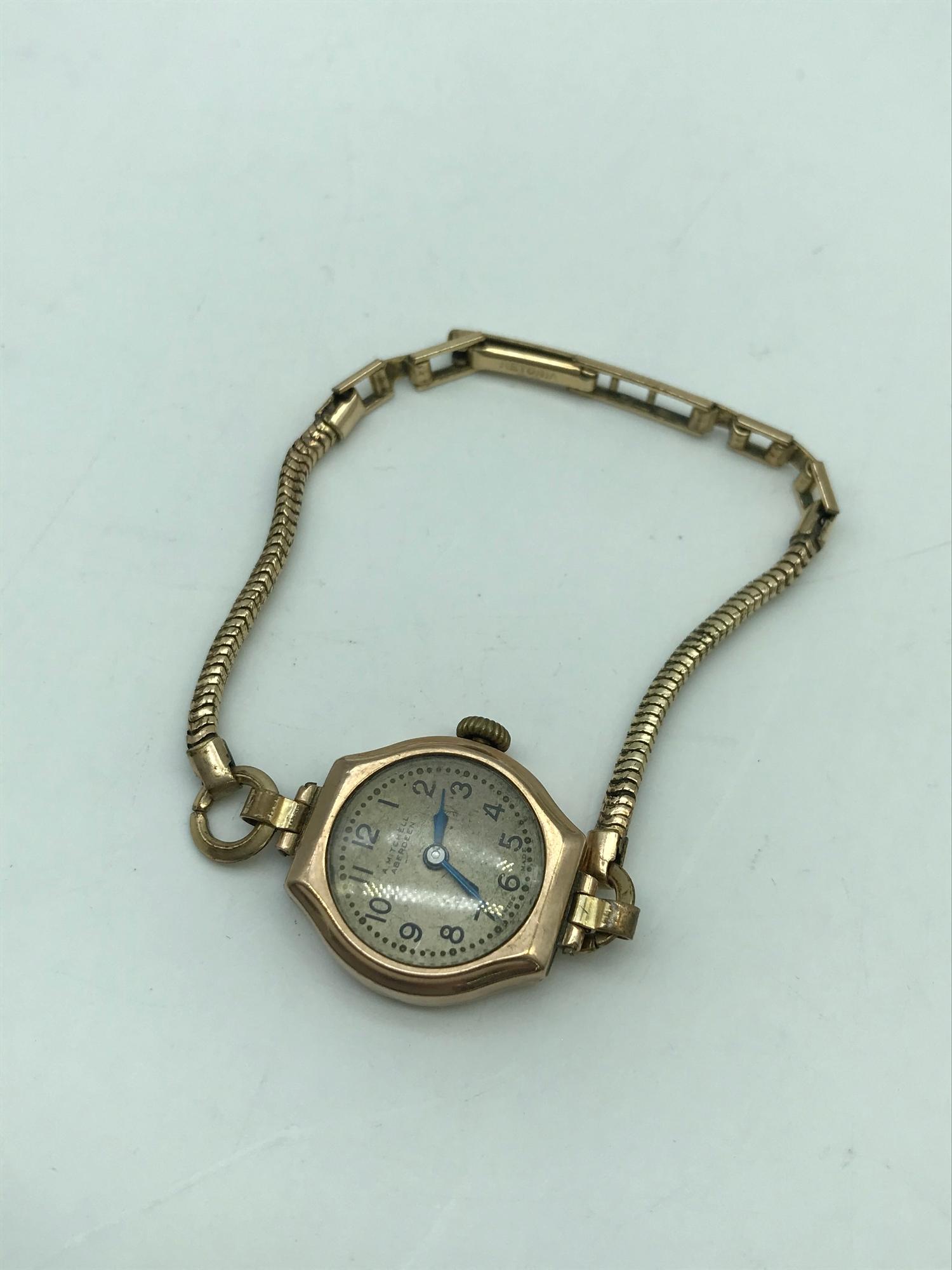 A Mitchell Aberdeen 9ct gold cased ladies watch with rolled gold strap.