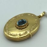 A Ladies 9ct gold locket pendant designed with a single blue aquamarine stone [total weight 4 grams]