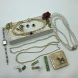 A Lot of vintage costume jewellery which includes; pearl necklaces with silver and plated clasps,