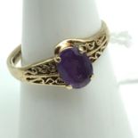 A Ladies 9ct gold ring ornately set with a single Amethyst stone. Ring size Q and weighs 2grams