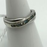 A Ladies 9ct gold twist ring set with CZ and blue Aqua Marine stones, ring size L and weighs 1.