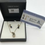 A Ladies 9ct gold sapphire and diamond pendant, chain and earring set. Comes with certificate of
