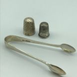 A set of Sheffield silver sugar tongs, together with a Chester silver Charles Horner thimble and one