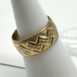 A Ladies 9ct gold engraved Wedding Band. Ring size K and weighs 3.3grams