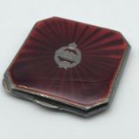 A Birmingham silver and red enamel compact. Designed with a tank corps Fear Naught silver insert.