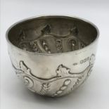 A London silver sugar bowl with raised ornate design. Maker John Henry Rawlings. Weighs 150.