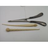 Two Victorian unusual grain carved button hooks, One in the shape of a Narwhal horn together with