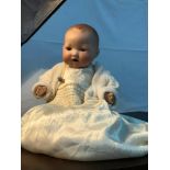 An early 1900's German bisque head doll. Has original sleepy eye movement. Stamped AM GERMANY 351/5K
