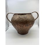 A 18th/ 19th century Hand Made Indian copper two handled urn. Detailed with A Large crown, Wolf/