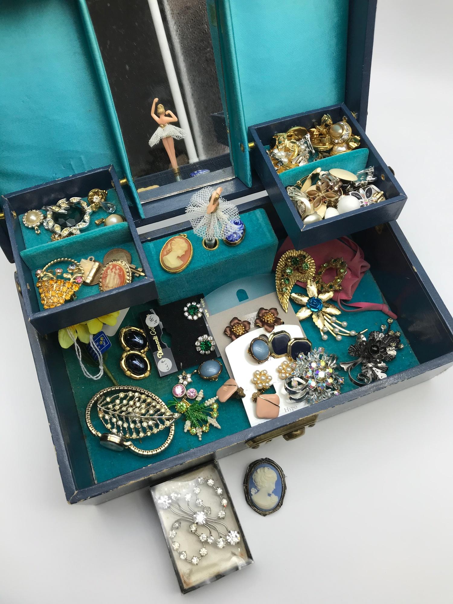 A Vintage jewellery box containing a quantity of vintage costume jewellery to include clip on