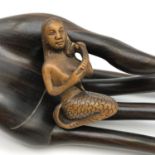 A Japanese hand carved netsuke figure of a Mermaid brushing her hair. Signed by the Artist.