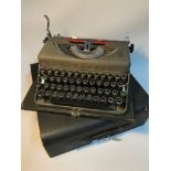 A Vintage Imperial Model T Typewriter with fitted top cover.