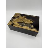 A Highly detailed Chinese/ Japanese lacquered box, detailed with gilt painted courtyard scene