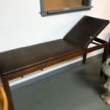 A Vintage examination bed, with rise and fall head rest. Also has a pull out writing slope.