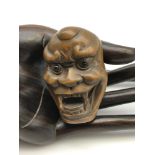 A Japanese hand carved netsuke figure of a traditional Japanese Hannya demon mask. Detailed with