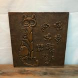 An Arts and Crafts copper raised cat and floral design wall plaque. [59x56cm]