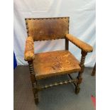 A 19th century oak and leather carver chair. Detailed with large stud finishes & Bobble supports.