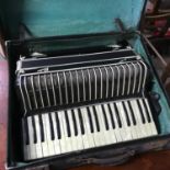 A Vintage Italian Pietro Deluxe full size piano accordion with travel case.
