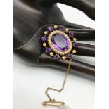 A Beautiful Victorian 9ct gold brooch set with a large Amethyst centre stone surrounded by seed