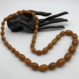 A Set of vintage egg yolk amber graduating beads, Weighs 68grams.