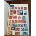 A Vintage stamp album containing a large quantity of world stamps.