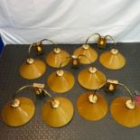 A Lot of five vintage wall lights designed with amber glass shades.