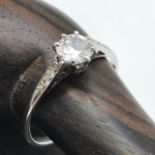 An Antique ladies 14ct white gold ring set with large single diamond off set by three diamonds to