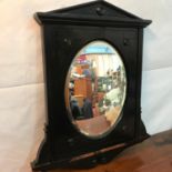 A Victorian Ebonised wooden framed convex mirror. [59cm in height]