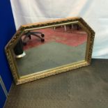 An ornate gilt framed over mantle mirror. Measures 64x95cm