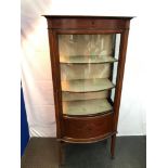 A Late Victorian/ Edwardian pedestal leg display cabinet. Designed with a bow front glass door,