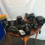 A Selection of vintage cameras to include Bellow Kodak Junior 1, Bellow camera, Tasco binoculars,