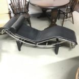 A vintage chrome and leather designer chaise longe. Designed on a metal stand