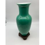 A mid 20th century Chinese Da Qing Qianlong Nian Zhi Green vase with hardwood stand. [As Found] [